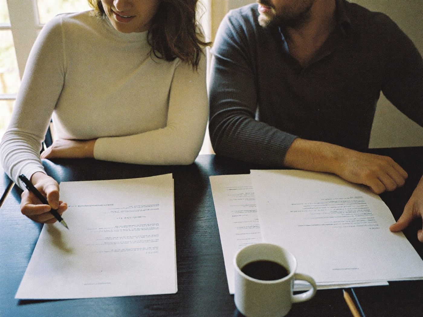 A couple reviewing a family agreement at their dining table