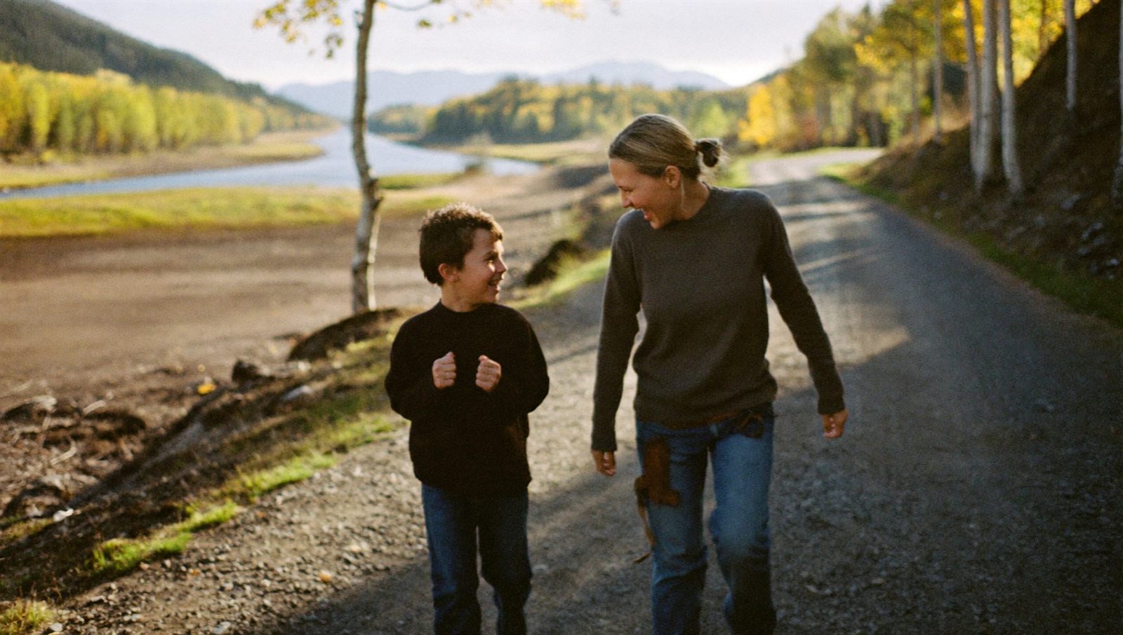 A mother and her son on a river valley trail